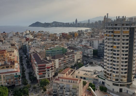 Evening view over Benidorm rooftops towards the skyline and Benidorm Island