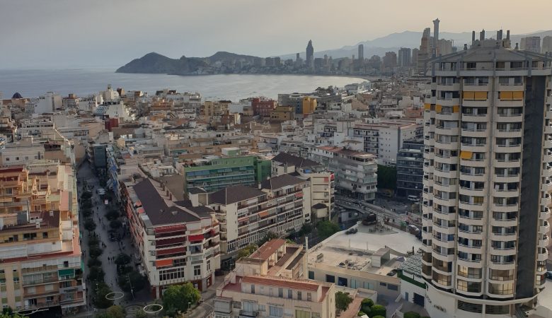 Evening view over Benidorm rooftops towards the skyline and Benidorm Island