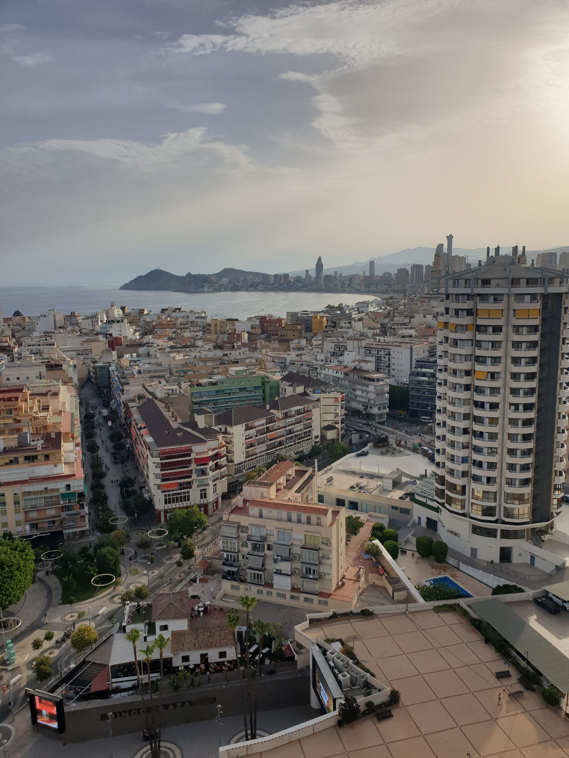 Evening view over Benidorm rooftops towards the skyline and Benidorm Island