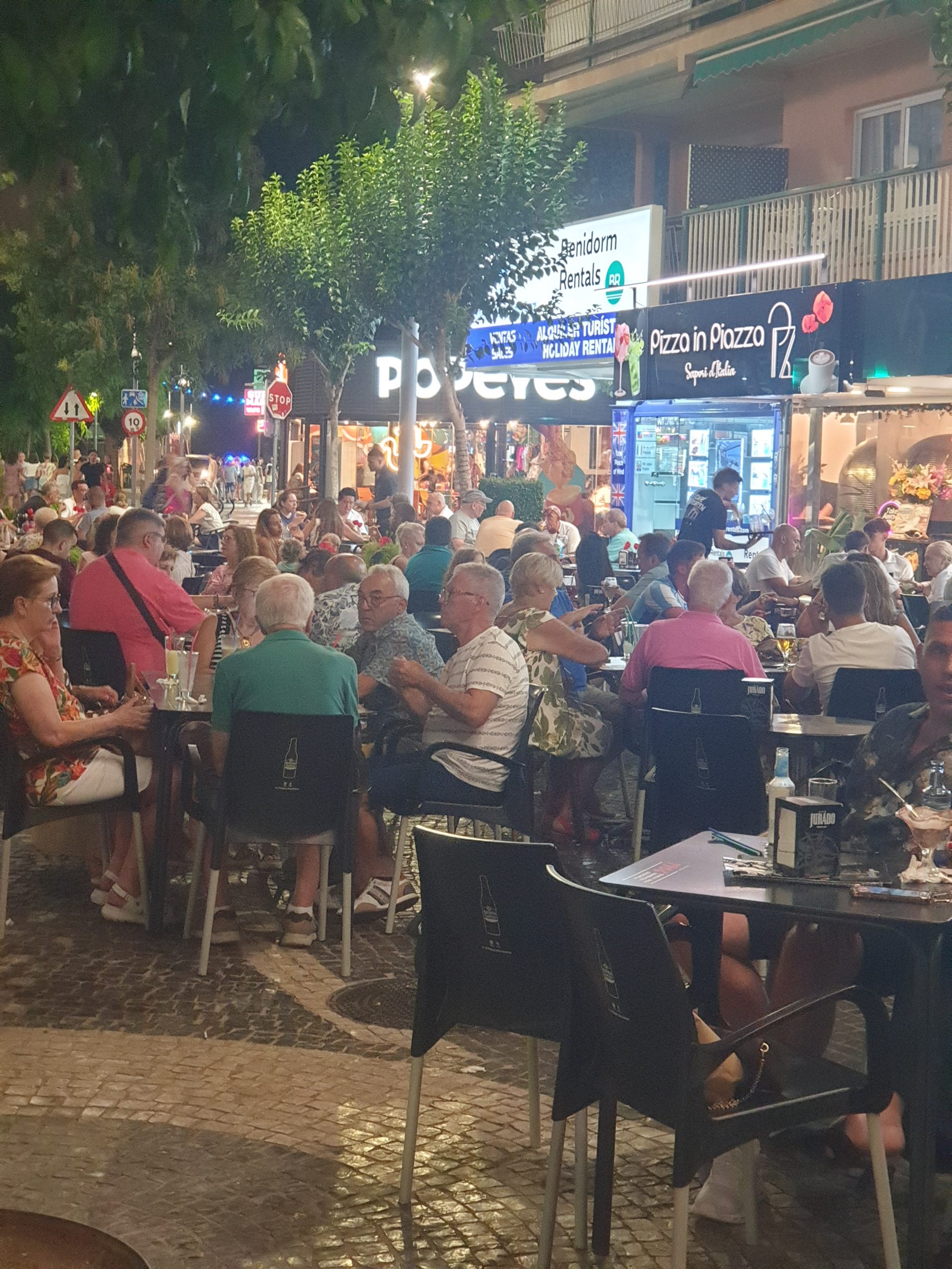Busy Placa Triangular terraces at night in Benidorm