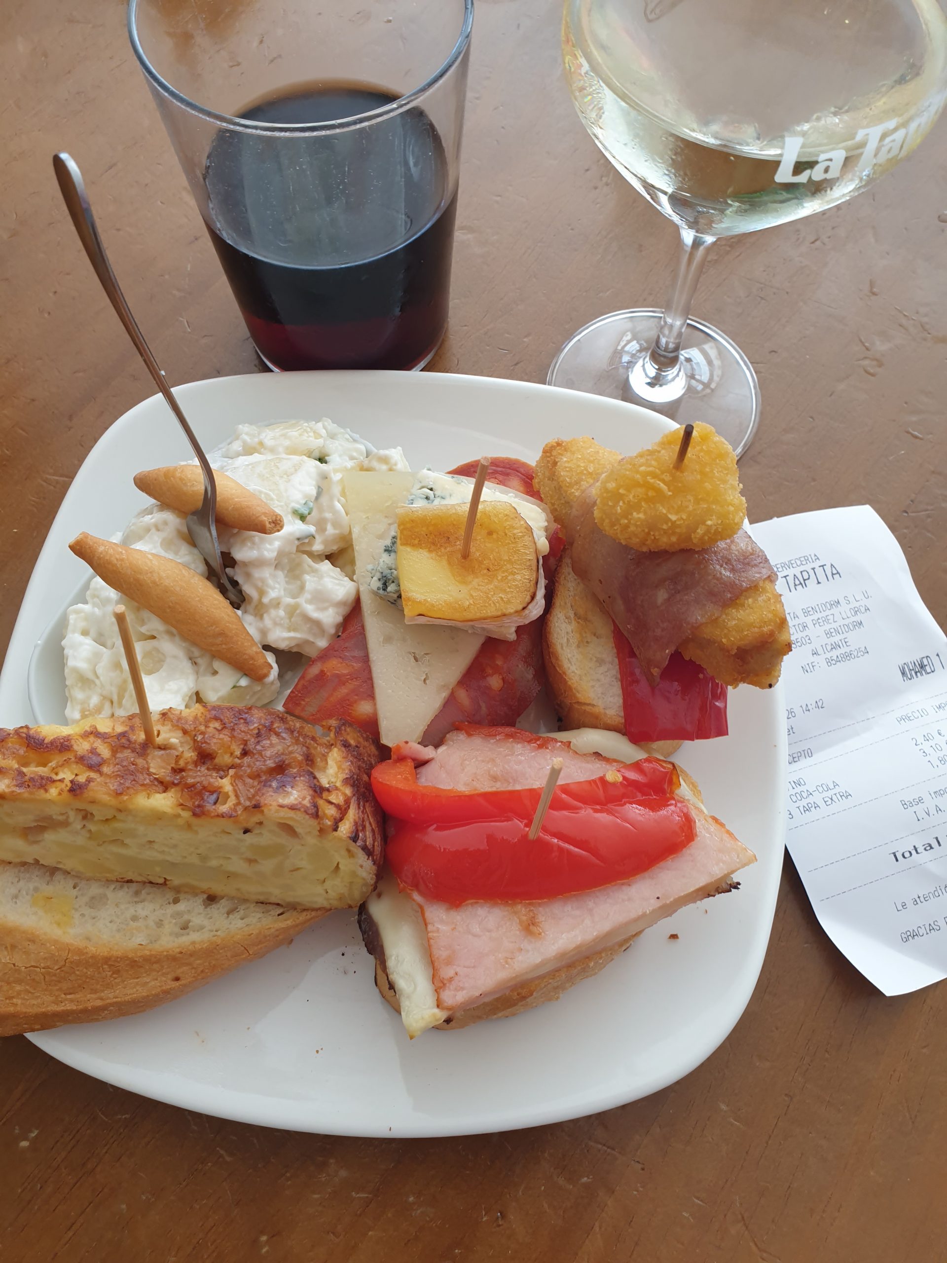 Plate of tapas at La Tapita, Benidorm, with the bill in shot