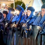 Members of a filà in blue robes shouldering muskets at the Moros y Cristianos in Benidorm