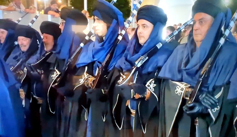 Members of a filà in blue robes shouldering muskets at the Moros y Cristianos in Benidorm