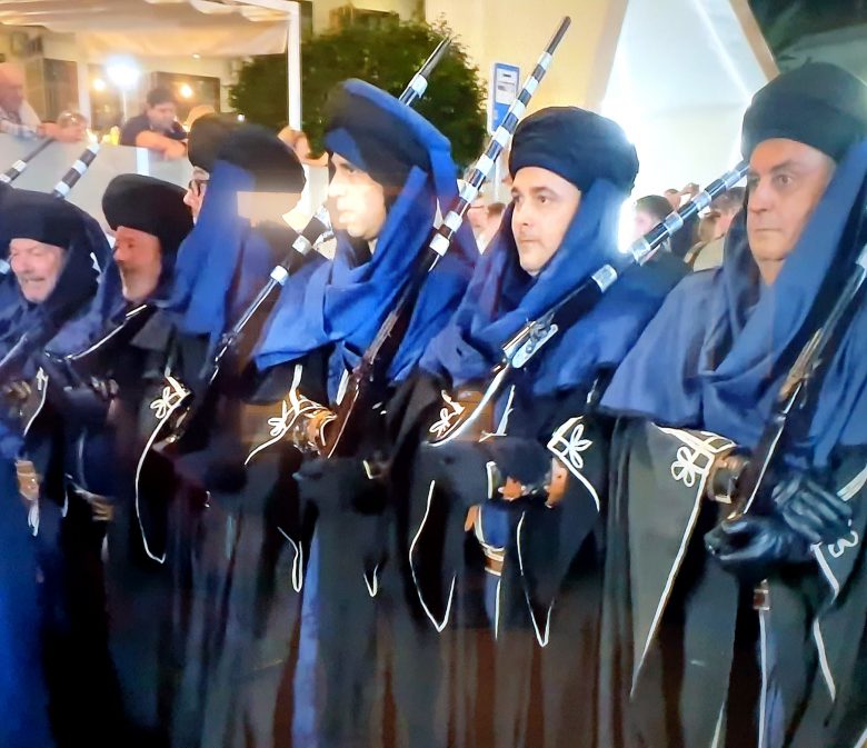 Members of a filà in blue robes shouldering muskets at the Moros y Cristianos in Benidorm