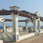 The tiled pergola and chequered promenade of the Balcón del Mediterráneo at the top of Benidorm Old Town, looking out to sea