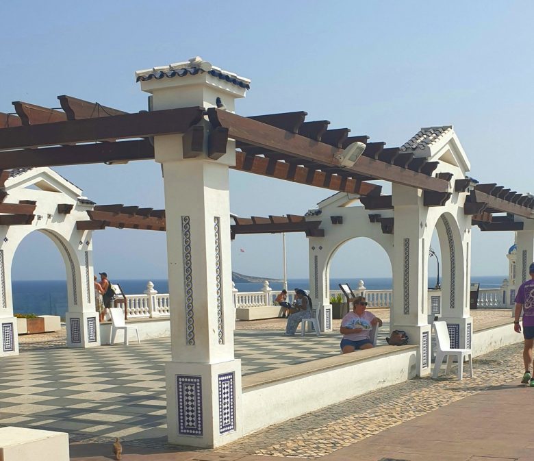 The tiled pergola and chequered promenade of the Balcón del Mediterráneo at the top of Benidorm Old Town, looking out to sea