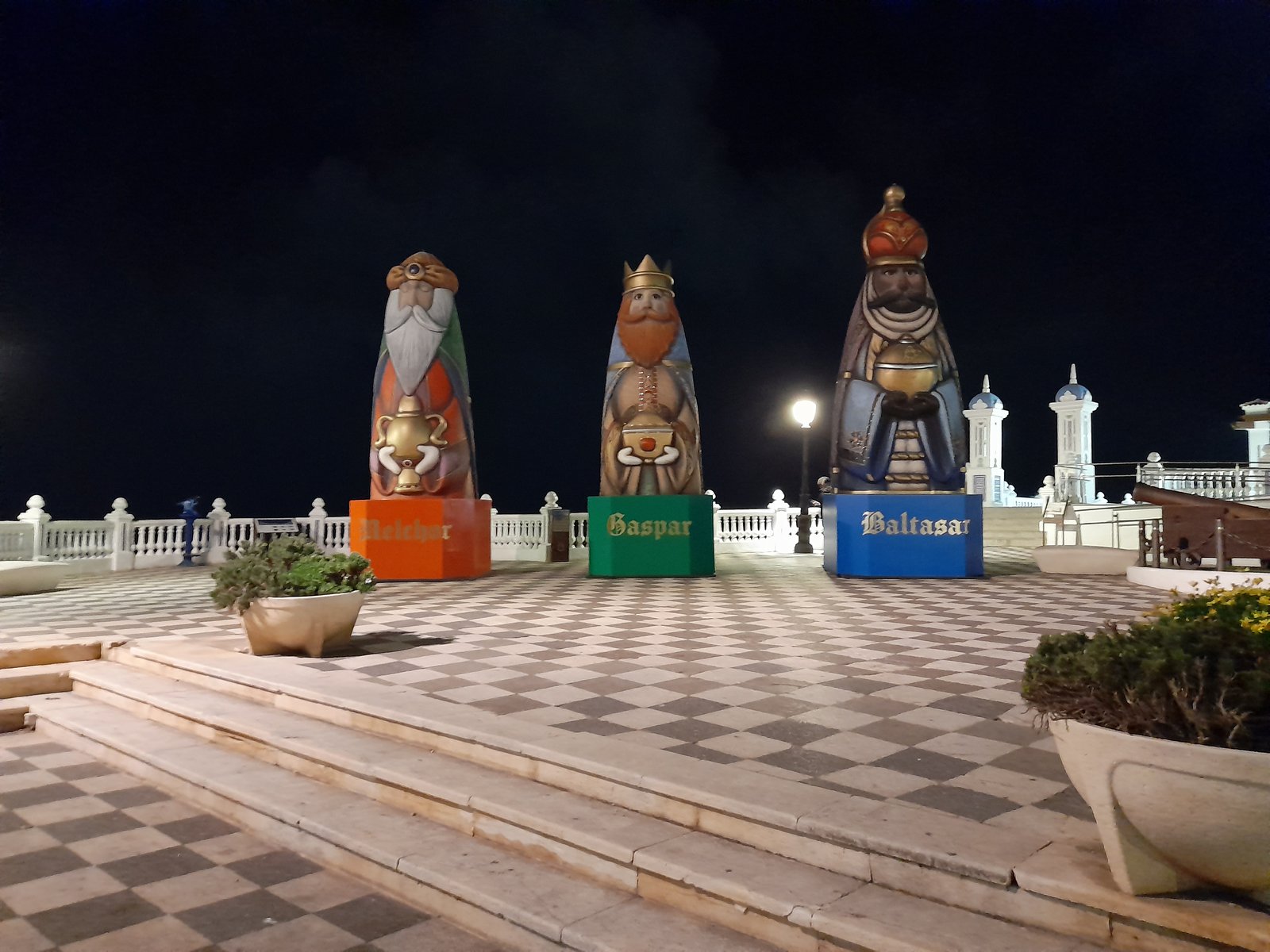 Giant figures of Melchor, Gaspar and Baltasar on the chequered terrace of the Balcon del Mediterraneo at night