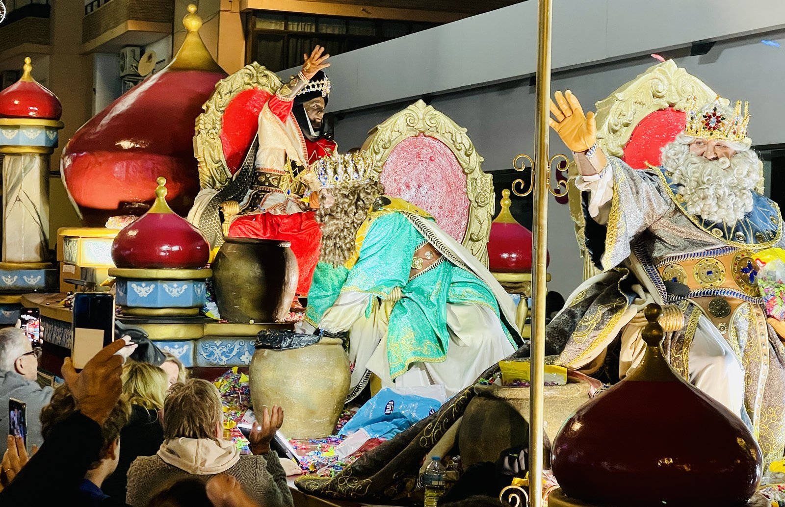 Two of the Three Kings on their float during the Benidorm cabalgata, crowd filming below