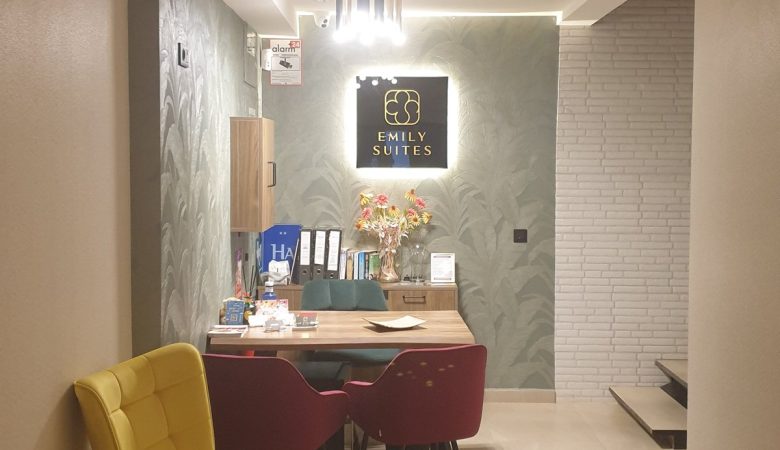Emily Suites reception in Benidorm Old Town, yellow armchair and lit sign